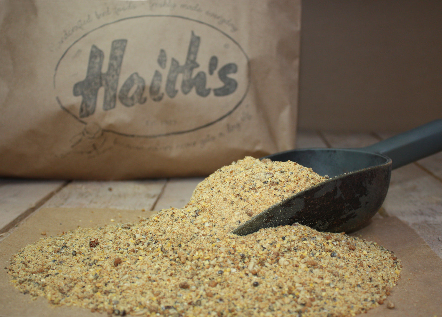 Haith's PTX fishing bait blend inside a scoop with a plastic bag behind it