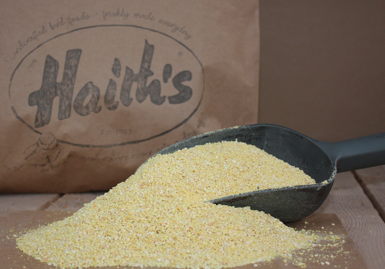 Haith's rearing and conditioning seed inside a scoop with a paper bag in the background