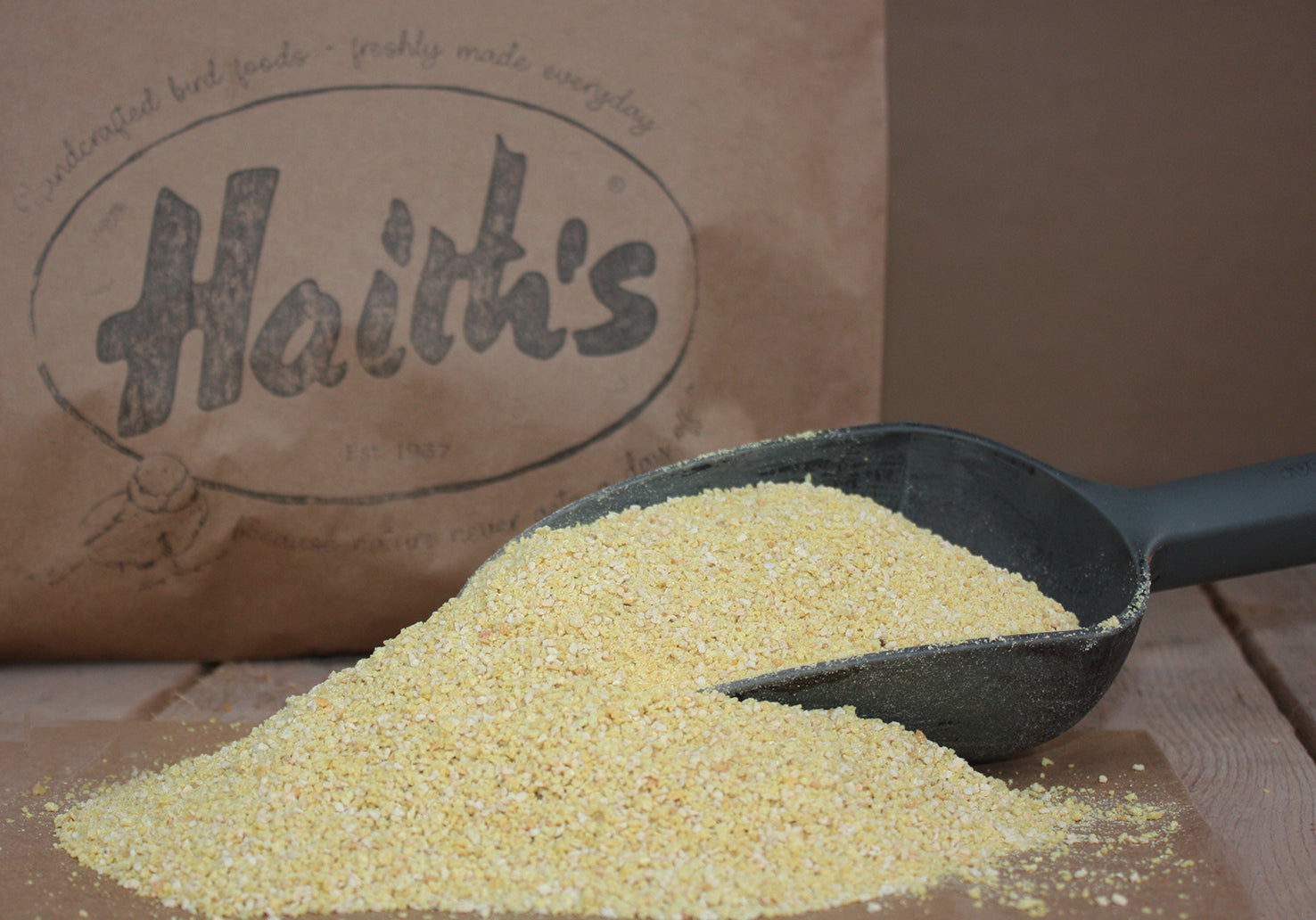 Haith's rearing and conditioning seed inside a scoop with a paper bag in the background 