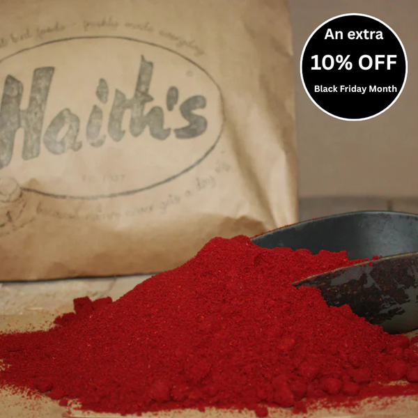 A scoop of Robin Red Bait Mix in front of a bag with the Haith's logo.